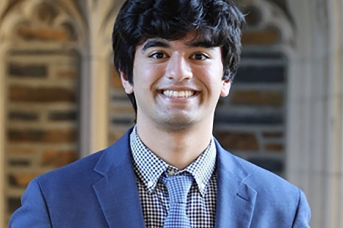 Ayush Jain wearing a light blue blazer, blue and white checked shirt and light blue patterned necktie.